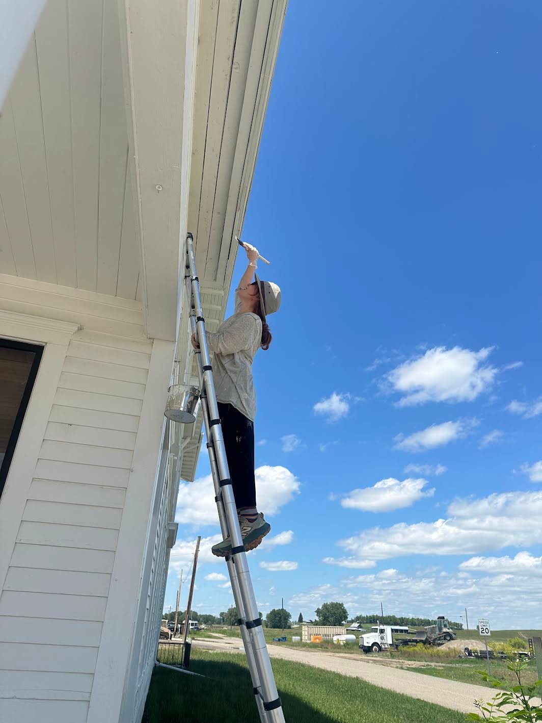 Volunteer painting the Adams Hotel exterior