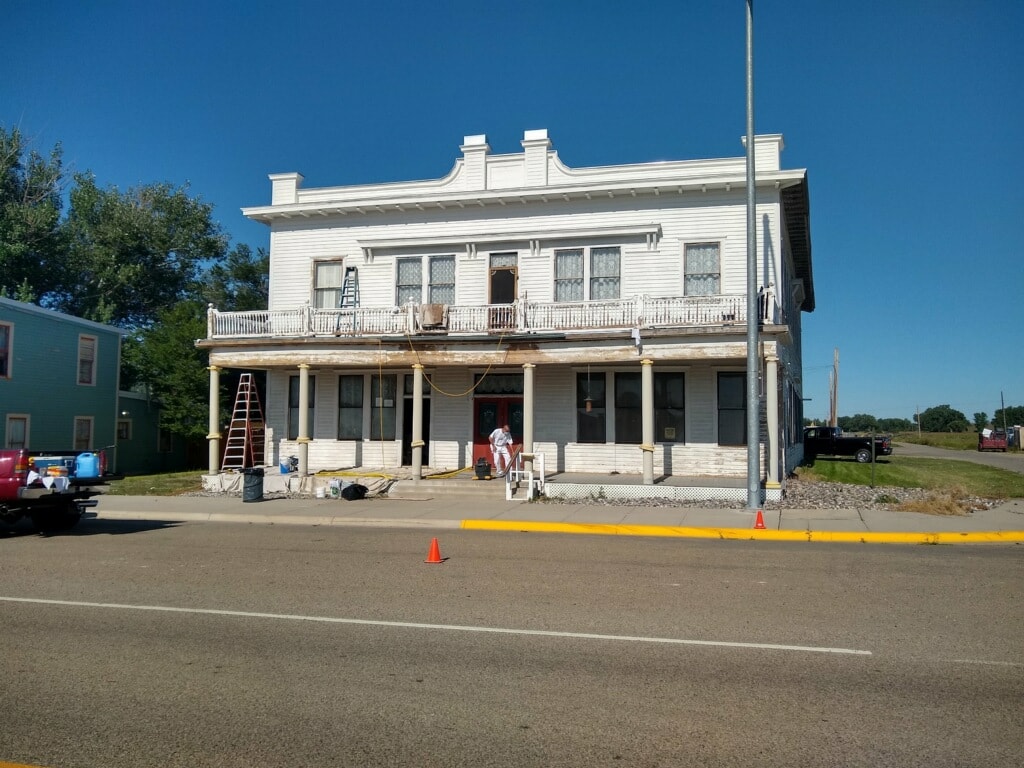 Adams Hotel front porch showing disrepair before restoration
